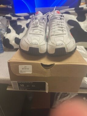 Nike Men's White Athletic Sneakers with Black Soles and Red Accents